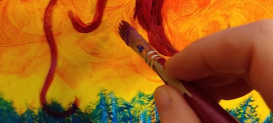 persons hand holding paintbrush, painting