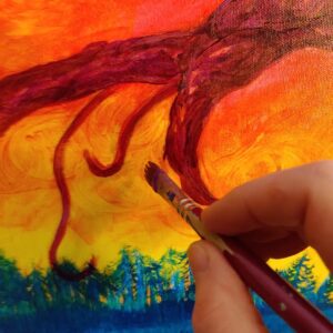 persons hand holding paintbrush, painting