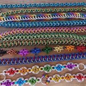 Close up of eleven chainmaille bracelets on a tabletop